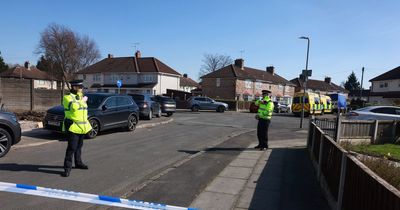 Road closed as armed police surround home