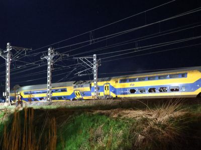 One dead and dozens injured as passenger train crashes into crane and derails in Netherlands