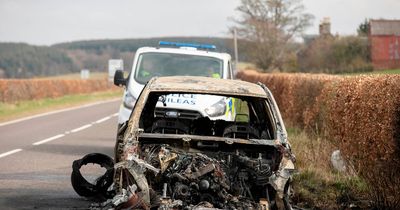 Police guard burnt out car on side of country road in South Ayrshire