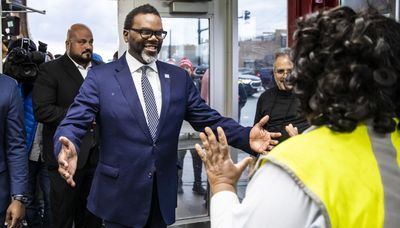 Mayor-elect Brandon Johnson greets voters outside the Chinatown Red Line L stop