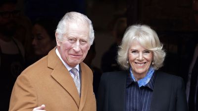 Queen Camilla's cropped black cape jacket adds a chic and unusual twist to her latest look