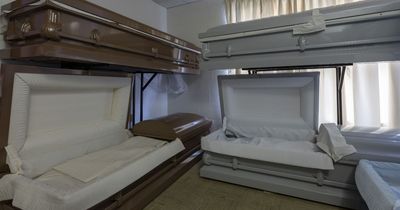 Inside lost funeral home filled with OPEN coffins and decaying hearse