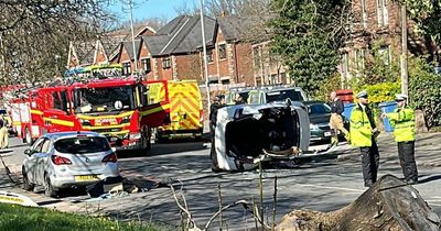 Car overturns in crash as driver cut out and taken to hospital