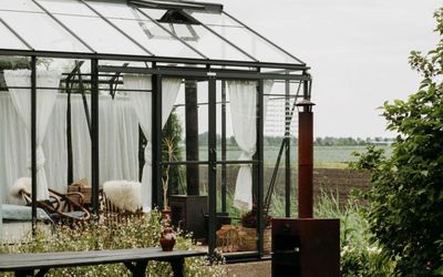 This tiny glass home in Holland is part of a trend for using greenhouses for more than growing
