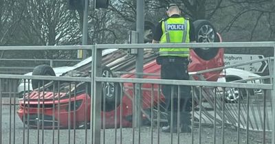 Car flips onto roof after crash on busy Glasgow road as woman charged