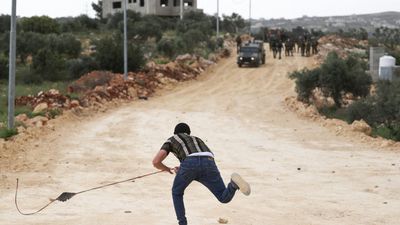 Israeli troops kill Palestinian teen in raid as settlers march through West Bank