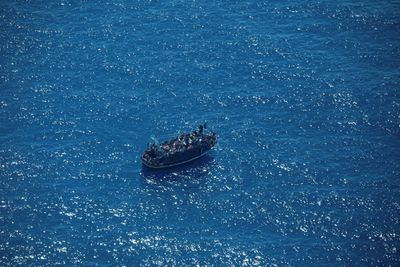 Italy's coastguard works to rescue 1,200 migrants drifting at sea