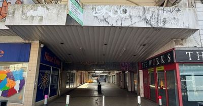 Inside eerie shopping centre with empty streets and just one store left