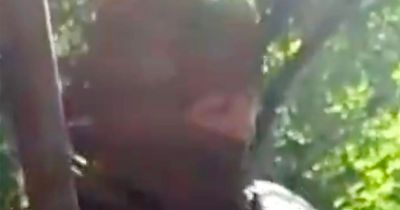 Russian soldier cuts Ukrainian's head off with knife in sick video posted online