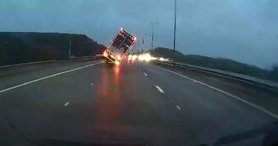 Dashcam video captures terrifying moment HGV is blown over by wind on motorway