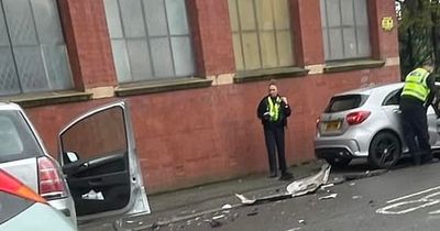 Police block off road after Mercedes crash as car bumper ripped off