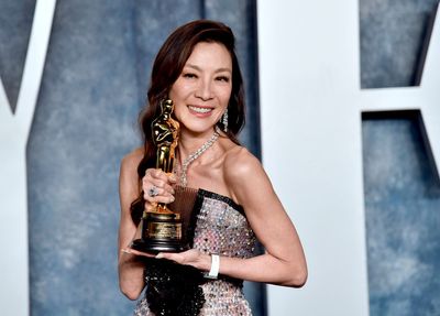Michelle Yeoh visits her father’s grave in Malaysia with her Oscars trophy
