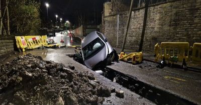 Driver ends up stuck in hole after ploughing through roadwork barriers