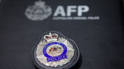 Australian Federal Police quit using controversial spit hoods in Canberra after review finds risks cannot be justified