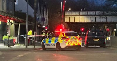 Police cordon off road after woman 'hit by taxi' and taken to hospital