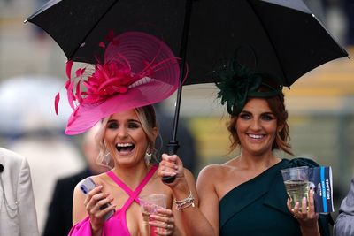 Racegoers brave downpours for Aintree’s Ladies Day