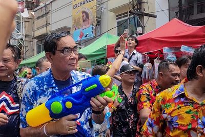 Thai PM gets a drenching in surprise water fight appearance