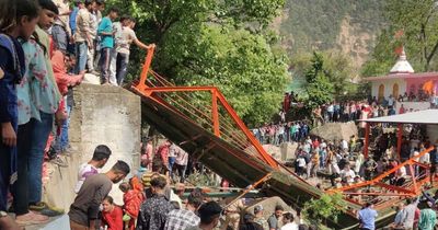 Girl, 10, killed and 70 injured as overcrowded footbridge collapses into rocky river