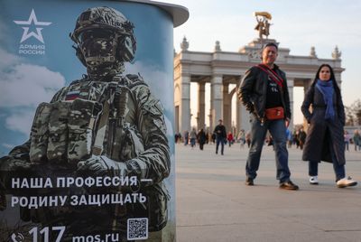 As Putin signs new law on draft, Russia says spring call-up is running as planned