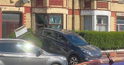 People evacuated after elderly driver reverses through front window