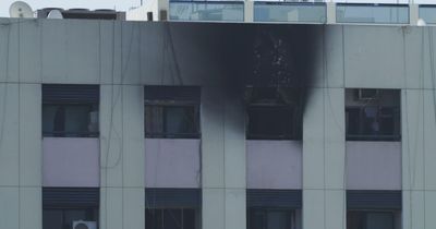 Sixteen dead as fire rips through apartment block while rescuers fought to save people