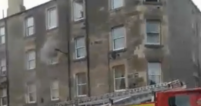 Fire crews race to Edinburgh flat blaze as two rushed to hospital for treatment