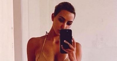 Kim Kardashian accused of Photoshop fail as fans spot 'missing finger' in bikini snap