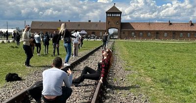 Woman poses for photo with head back 'like a model' at Auschwitz Nazi death camp