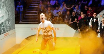 Just Stop Oil protestors stop play at World Snooker Championship after throwing orange powder paint on table