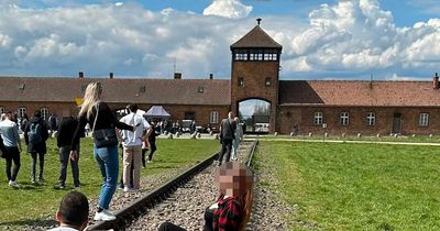 Auschwitz museum urges visitors to respect site after woman's photo sparks fury
