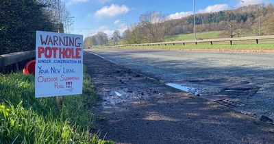 Driver puts up comedy 'swimming pool' sign next to pothole