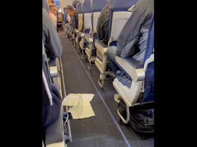 Flight attendant won’t let plane leave until passengers clean up mess dropped in the aisle