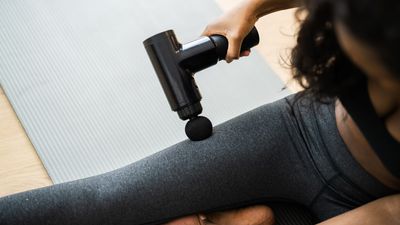 How to use a massage gun on your legs after a marathon