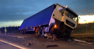 M1 crash as Lorry left hanging off bridge as driver made 'lucky escape' in collision near junction 20