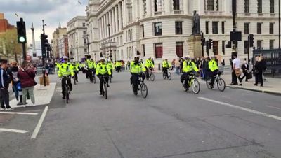 Dozens of jogging police officers escort Rishi Sunak’s car in huge motorcade through London