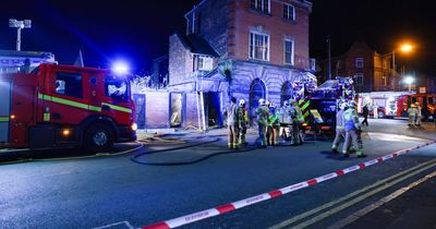 Flat bursts into flames as firefighters check for people inside