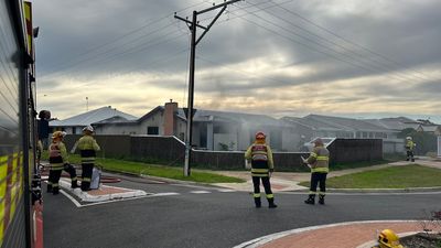 Woman in hospital and man charged with assault after house fire in Adelaide's west