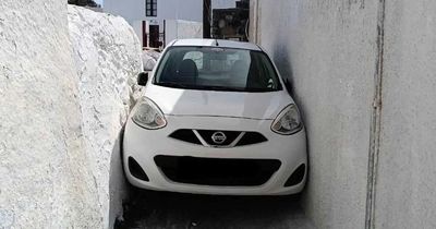 Tourist wedges car in narrow alley after taking wrong turn on Greek island