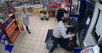 Dramatic moment shopkeeper tackles masked robber and 'smacks him around the gob'