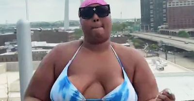 Lizzo shows off flexibility in tiny string bikini while dancing on hotel balcony