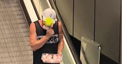 Man caught on camera munching down on raw chicken in busy shopping centre