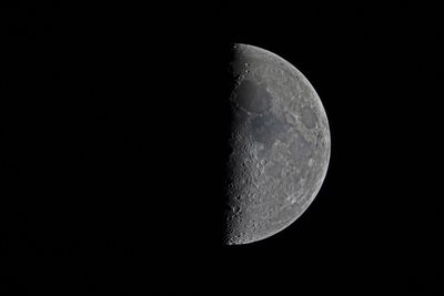 Look up and see the half-lit first quarter moon buzz the Beehive Cluster tonight