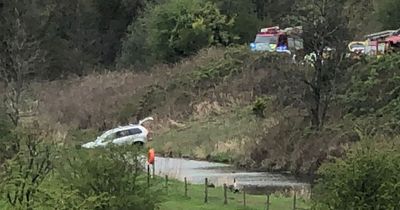 Men arrested on suspicion of making 'threats to kill' after altercation sees car career off road and into water