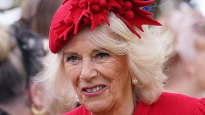 Queen Camilla’s bright red tunic dress and hat prove bold colors are still a royal go-to and her brooch is equally stand-out
