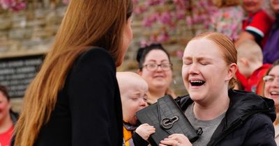 Adorable moment baby steals Kate's £675 designer bag and won't give it back on royal visit to Wales