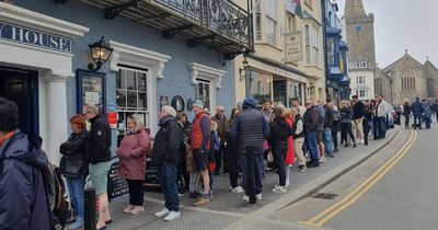 Tourists queue down the street to get into pub in one of Britain's busiest seaside towns
