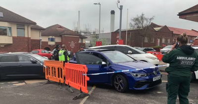 Bullet-riddled car found outside hospital after man admitted with 'gunshot wounds' as police lock down scene