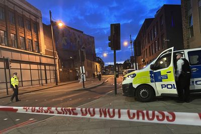 Relatives pray at police cordon after woman fatally stabbed in broad daylight