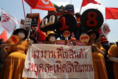 Workers march to demand higher pay