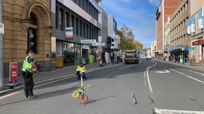 Tasmania Police officer struck by garbage truck in Launceston's CBD